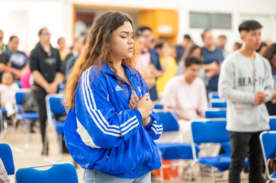 A diverse group of young adults engaged in a worship session at a church in Mexico City.